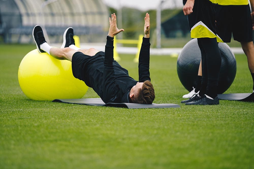 Young,Coach,Showing,To,Junior,Players,How,To,Exercise,Properly