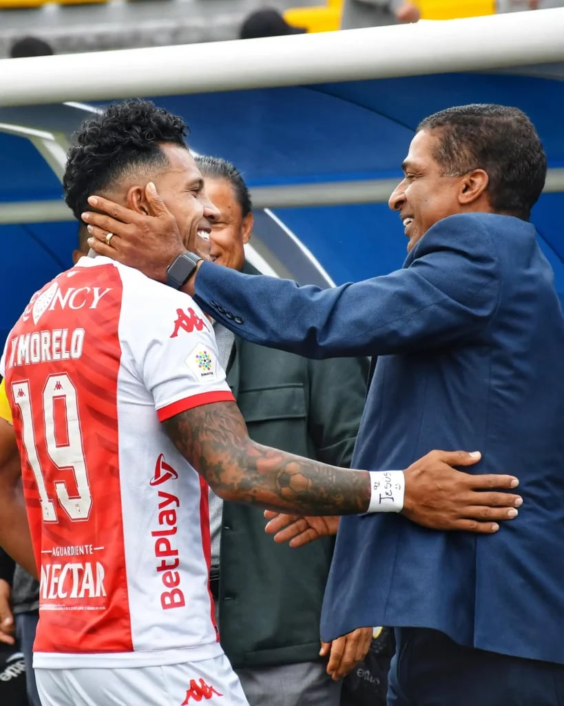 a football player being congratulated by his coach