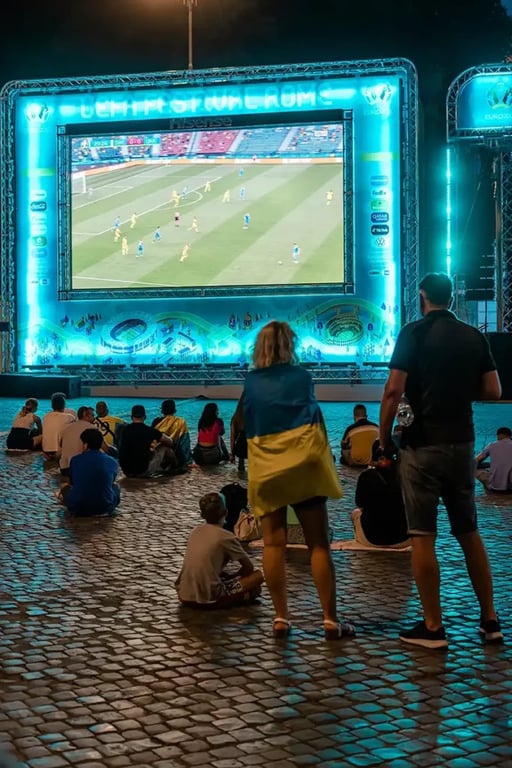 People Watching Soccer Match on Large Screen