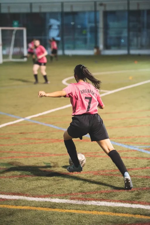 Women Soccer Player Kicking Ball