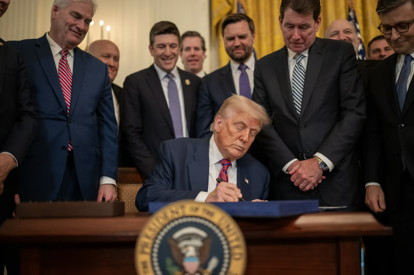 President Donald Trump signing the GENIUS Act, highlighting stablecoin regulation and dollar-backed crypto policy.