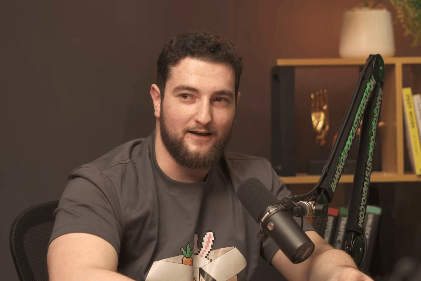 A crypto researcher sits at a podcast microphone in a studio setting, with a caption noting a move from Ethereum research to Solana.