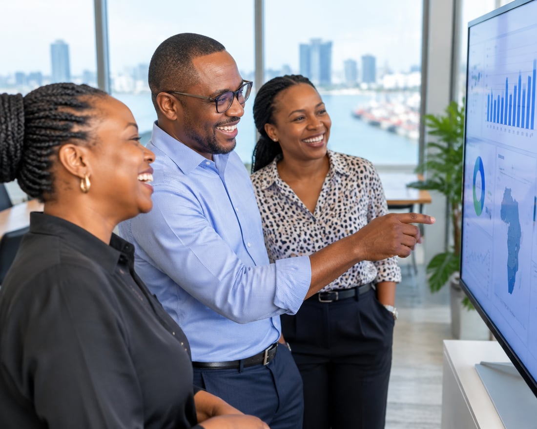 Tanzanian professionals reviewing a dashboard in a Dar es Salaam office