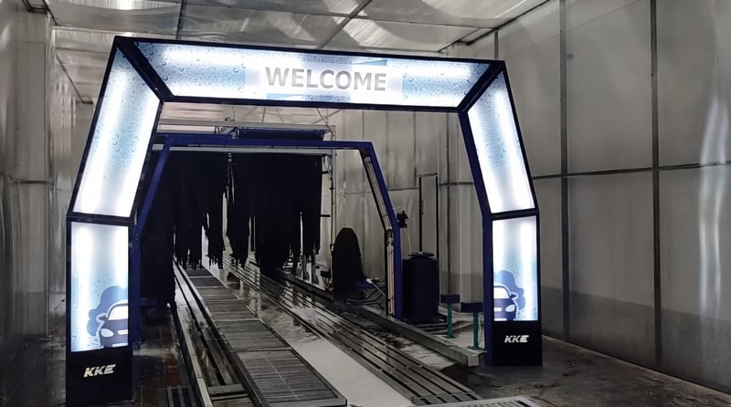 The lit entry portal of a KKE Gamma conveyor tunnel, WELCOME showing on the arch