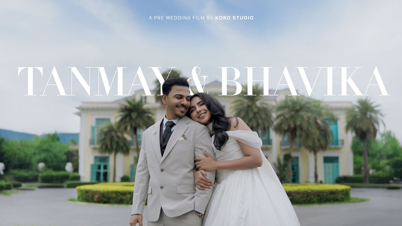 Tanmay and Bhavika posing in front of the yellow manor at Chateau de Khaoyai.
