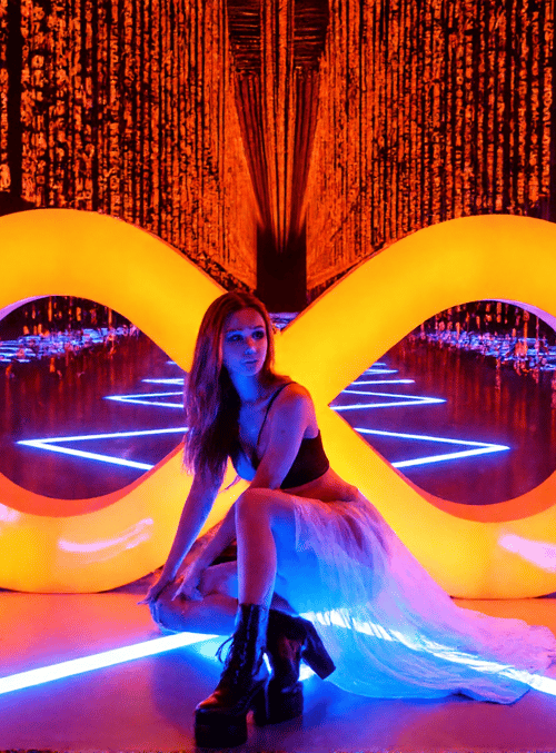 woman, infinity symbol, binary code, neon lights, dress, boots, curtains, floor