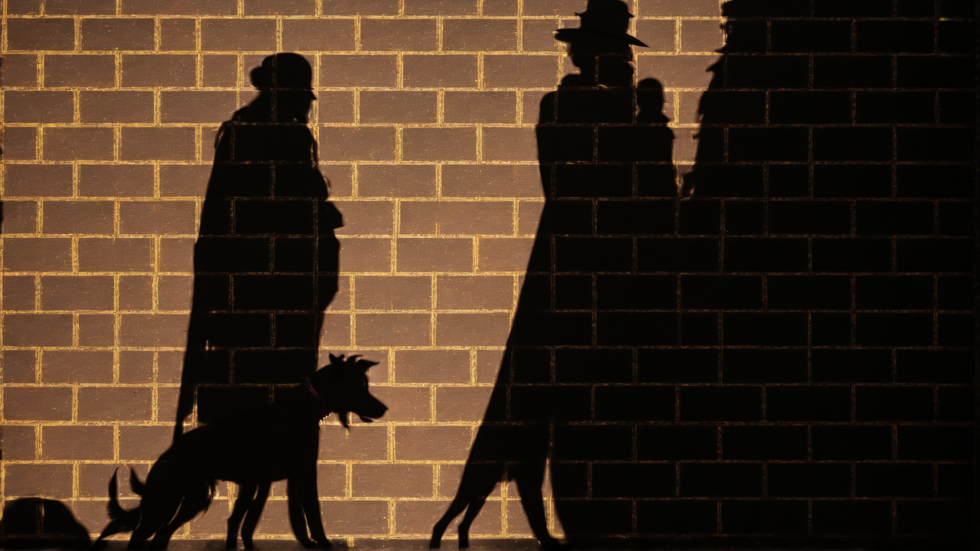 AI generated wallpaper featuring silhouette, people, dog, wall, shadow, brick, hat, walking