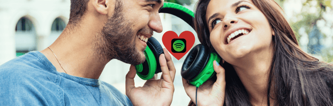 A man and woman are listening to music with headphones on.