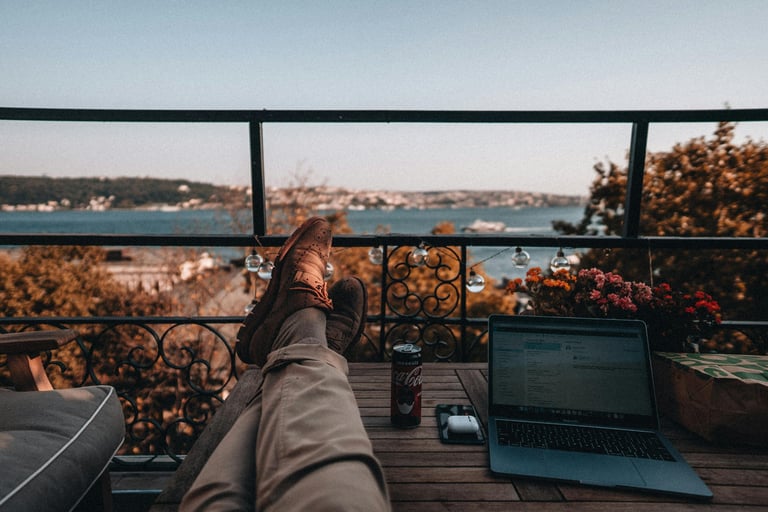 Freelancer's workspace on an open terrace with sea and coastal views