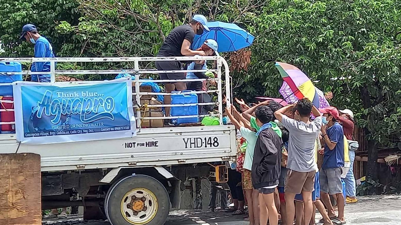 Héroe local Joel Baldonasa proporciona agua limpia a familias afectadas por la erupción del volcán.