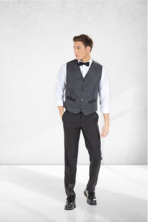 A man wearing black pants, a white shirt and a black hospitality vest made by unifardas