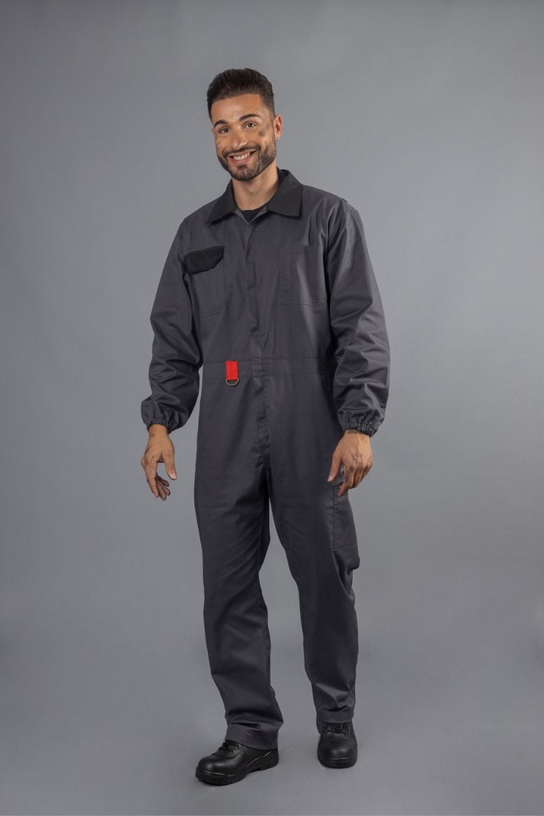 A man wearing a Coverall for Industrial Workwear, designed and manufactured by Unifardas as part of professional workwear.