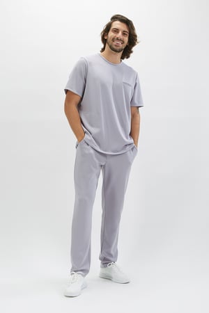 Man dressed in a health tunic to be used as a Professional Uniform manufactured by Unifardas