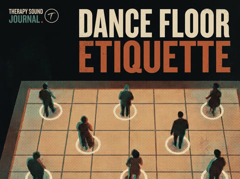 Silhouettes of dancers moving together on a dimly lit dance floor with warm lighting