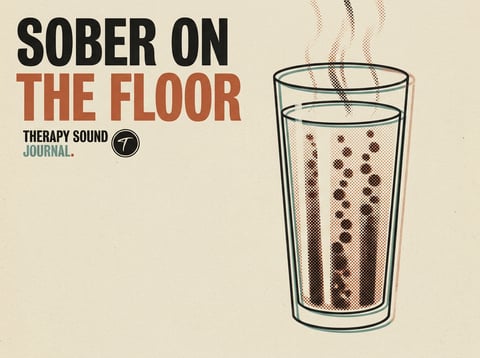 A crowd dancing on a dark house-music floor, lit by warm stage light — sober on the floor at Therapy Sound.