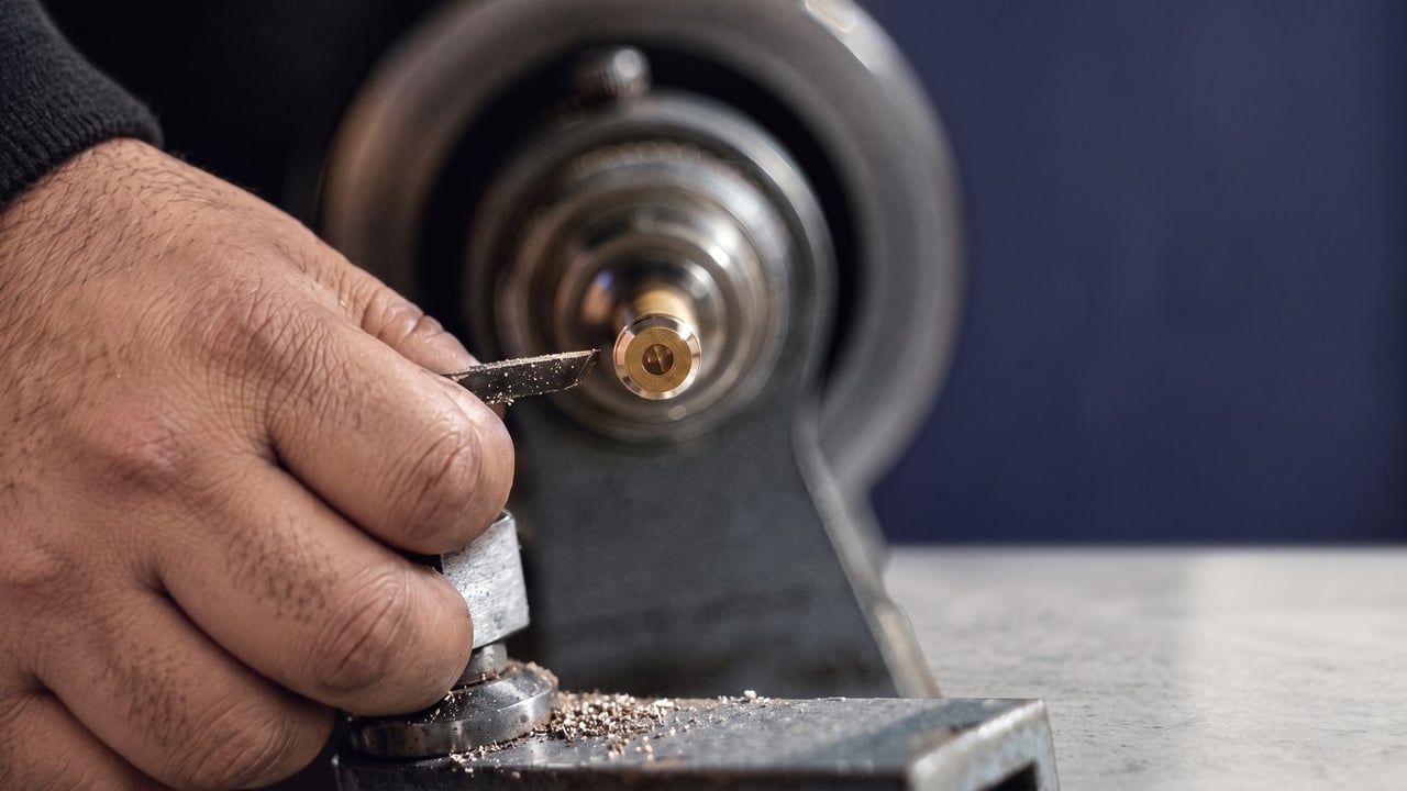 House key being cut on a key duplicating machine