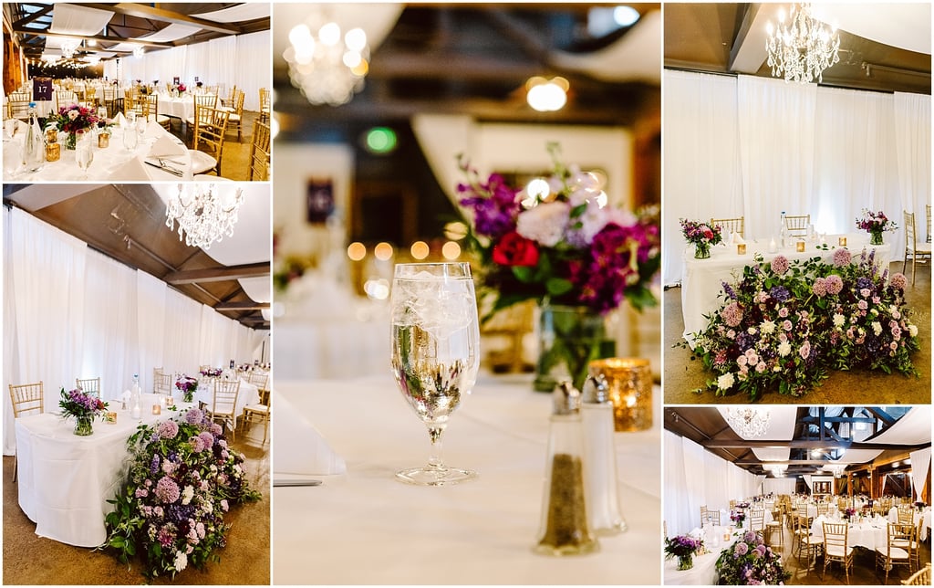 Wedding reception hall with white draped walls, gold chairs, and tables set with white linens and purple-pink floral centerpieces.