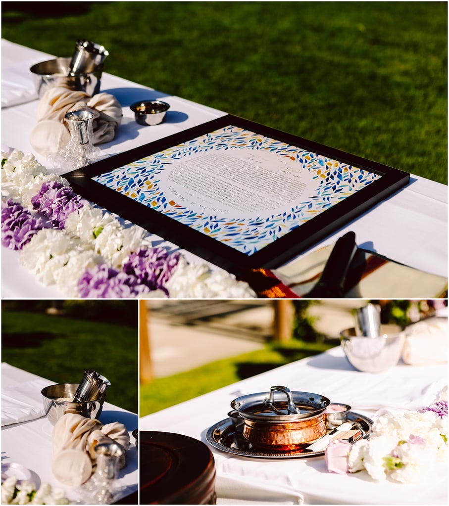 Outdoor table with a framed decorative document surrounded by flowers and ceremonial vessels (copper pots) on a white cloth.