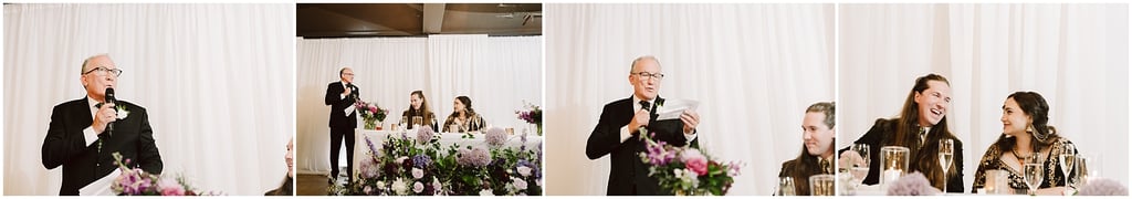 Older man in a black suit and tie speaks into a microphone at a wedding reception, against a white draped backdrop.