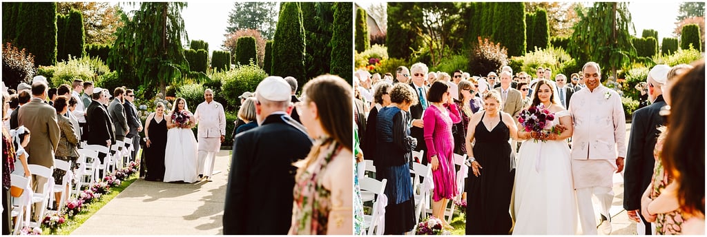 Outdoor wedding procession: bride in white gown and groom in light suit walking down an aisle lined with chairs and guests holding bouquets.