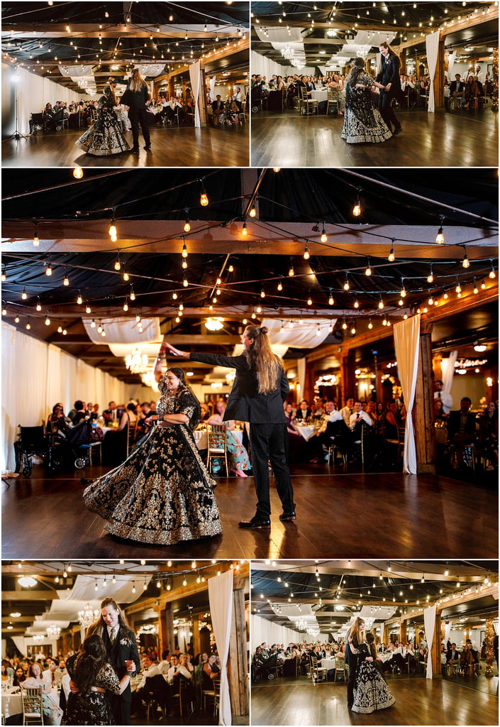 Couple dancing on a wooden floor under warm string lights at a wedding reception, with guests seated at tables in the background.