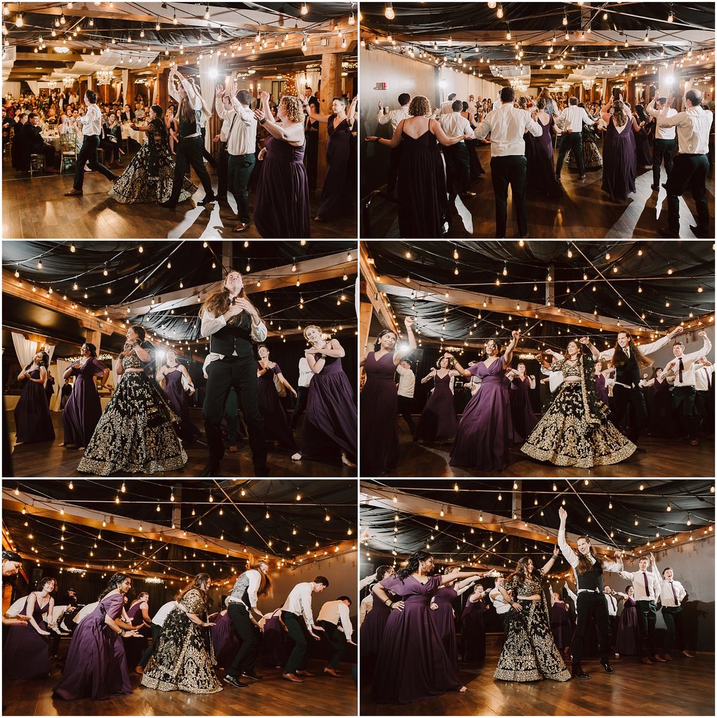 Guests dance together at a wedding reception under warm string lights and chandeliers in a decorated hall