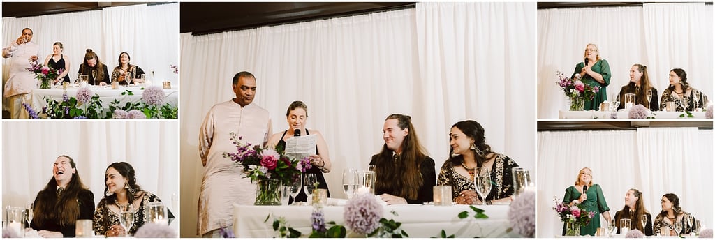 Group of people at a head table during a formal reception; a woman speaks into a mic while others listen, flowers in front.