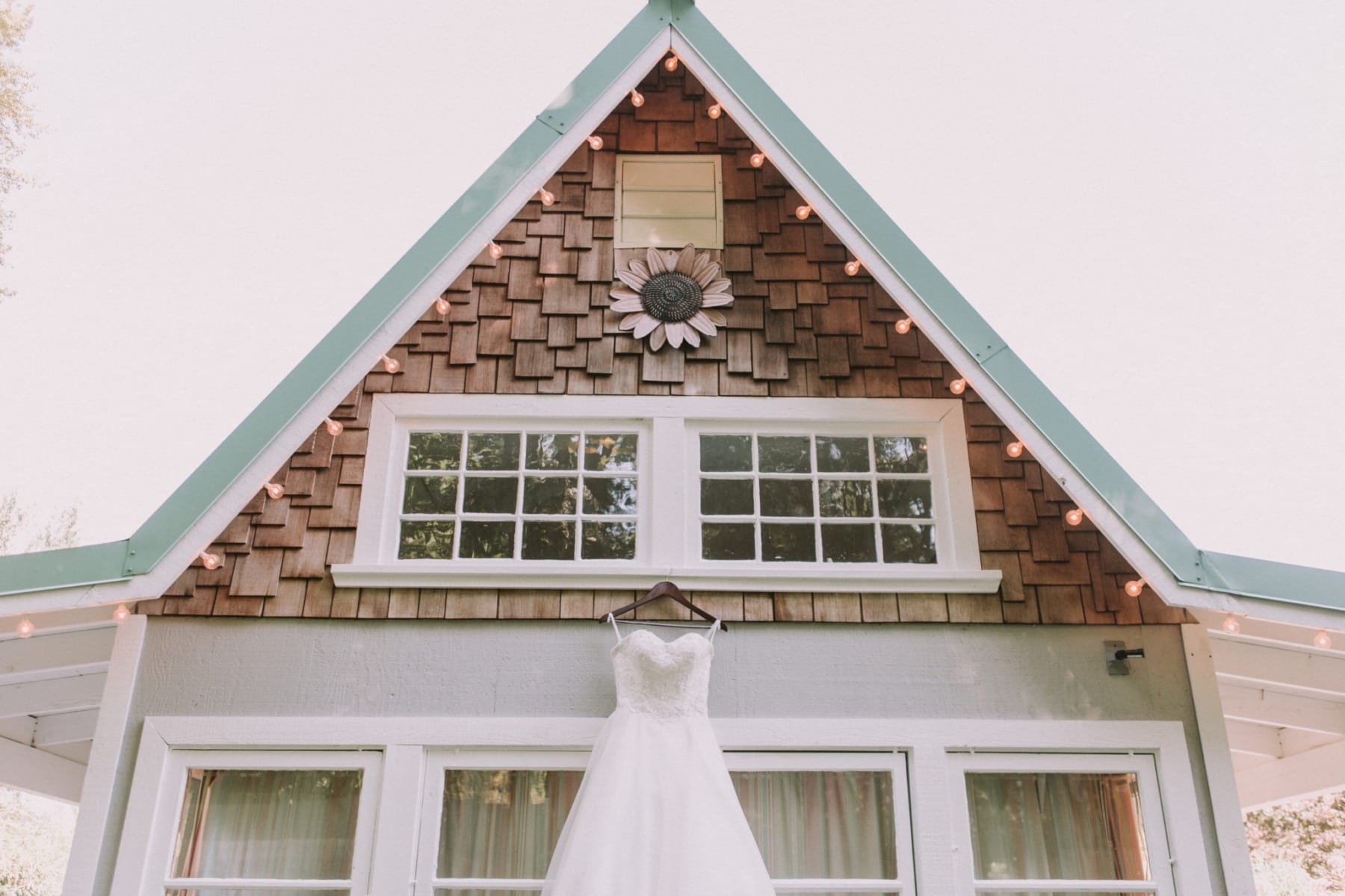 summer garden wedding at shooting star garden dress hanging on the garden house