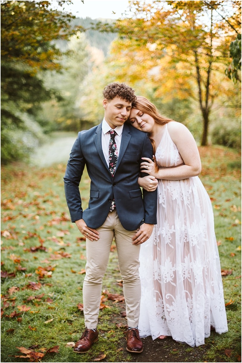 Premier Snohomish Seattle Wedding Photographer | GSquared Weddings Photography A couple stands outdoors in a park with autumn leaves The woman in a white lace dress rests her head on the mans shoulderboth calm and content during their Snohomish Seattle wedding engagement session 479129° N 1220982° W | Serving Snohomish Seattle Orlando Beyond Premier Snohomish & Seattle Wedding Photographer | GSquared Weddings Photography A couple stands outdoors in a park with autumn leaves The woman in a white lace dress rests her head on the mans shoulderboth calm and content during their Snohomish Seattle wedding engagement session 479129° N 1220982° W | Serving Snohomish Seattle Orlando & Beyond
