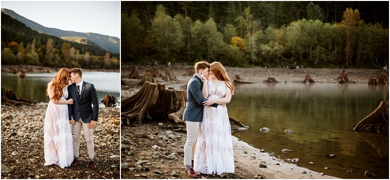 Premier Snohomish & Seattle Wedding Photographer | GSquared Weddings Photography A couple stands by a serene lake near Snohomish, surrounded by trees and mountains, holding hands and embracing. The woman wears a long white dress, the man a suit jacket and light pants. The scene feels calm and romantic—perfect for a Seattle wedding engagement. 47.9129° N, 122.0982° W | Serving Snohomish, Seattle , Orlando & Beyond