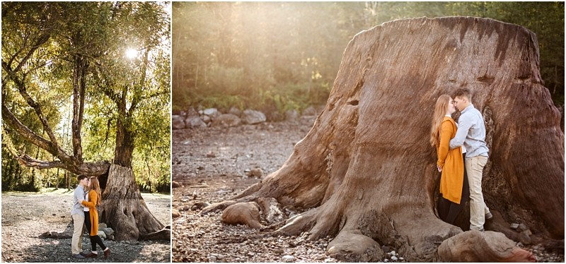 Premier Snohomish & Seattle Wedding Photographer | GSquared Weddings Photography A couple stands close together outdoors; on the left, they embrace beneath a large tree, while on the right, they lean against a massive tree stump in soft sunlight during their Snohomish Seattle wedding engagement. 47.9129° N, 122.0982° W | Serving Snohomish, Seattle , Orlando & Beyond