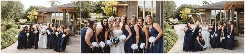 Premier Snohomish & Seattle Wedding Photographer | GSquared Weddings Photography A bride in a white dress poses outdoors with her bridesmaids in navy blue dresses, holding white bouquets, smiling and celebrating a Snohomish Seattle wedding in front of a modern building and lush greenery. 47.9129° N, 122.0982° W | Serving Snohomish, Seattle , Orlando & Beyond