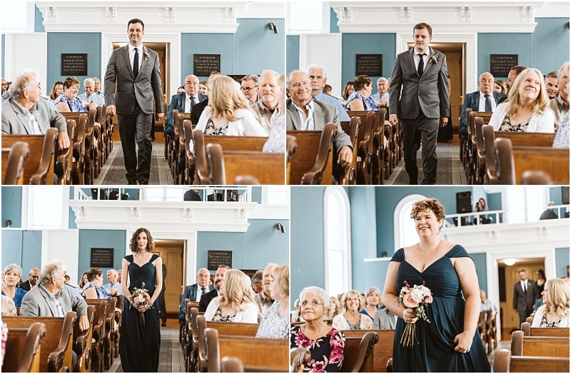 Premier Snohomish & Seattle Wedding Photographer | GSquared Weddings Photography Four people, two men in suits and two women in dark dresses holding bouquets, walk down the aisle of a church filled with guests during a beautiful Snohomish Seattle wedding ceremony. 47.9129° N, 122.0982° W | Serving Snohomish, Seattle , Orlando & Beyond