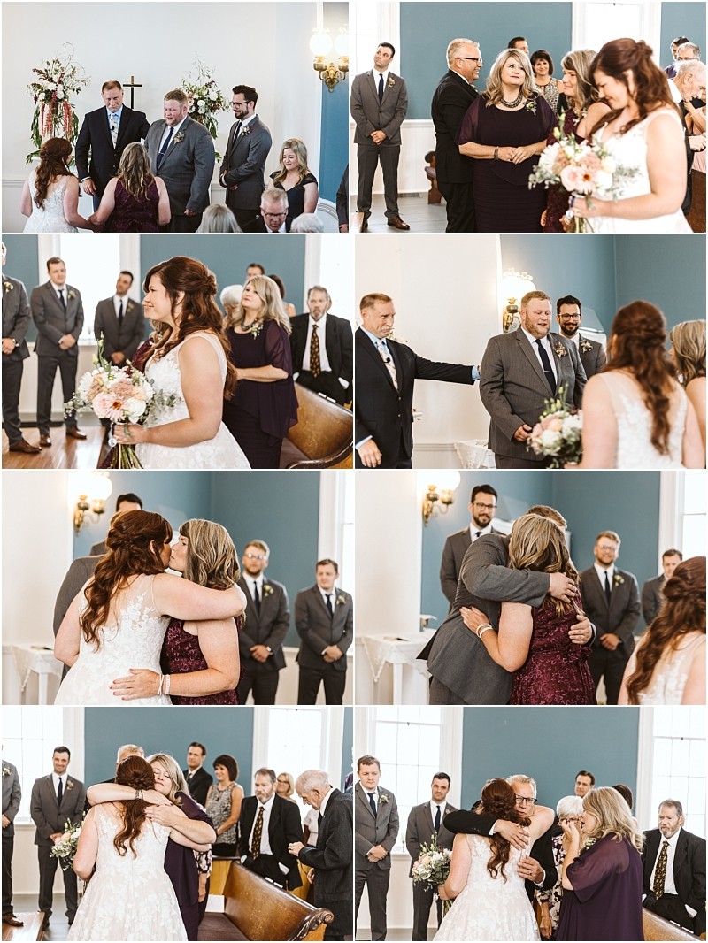 Premier Snohomish & Seattle Wedding Photographer | GSquared Weddings Photography A bride hugs and shares emotional moments with loved ones during a Snohomish wedding ceremony in a bright room, with guests and groomsmen from Seattle watching and smiling. 47.9129° N, 122.0982° W | Serving Snohomish, Seattle , Orlando & Beyond