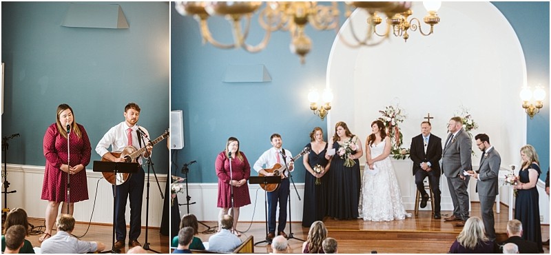 Premier Snohomish & Seattle Wedding Photographer | GSquared Weddings Photography A beautiful Snohomish wedding ceremony takes place in a church. On the left, a man with a guitar and a woman sing to guests. On the right, the wedding party stands on stage near flowers and an officiant. 47.9129° N, 122.0982° W | Serving Snohomish, Seattle , Orlando & Beyond