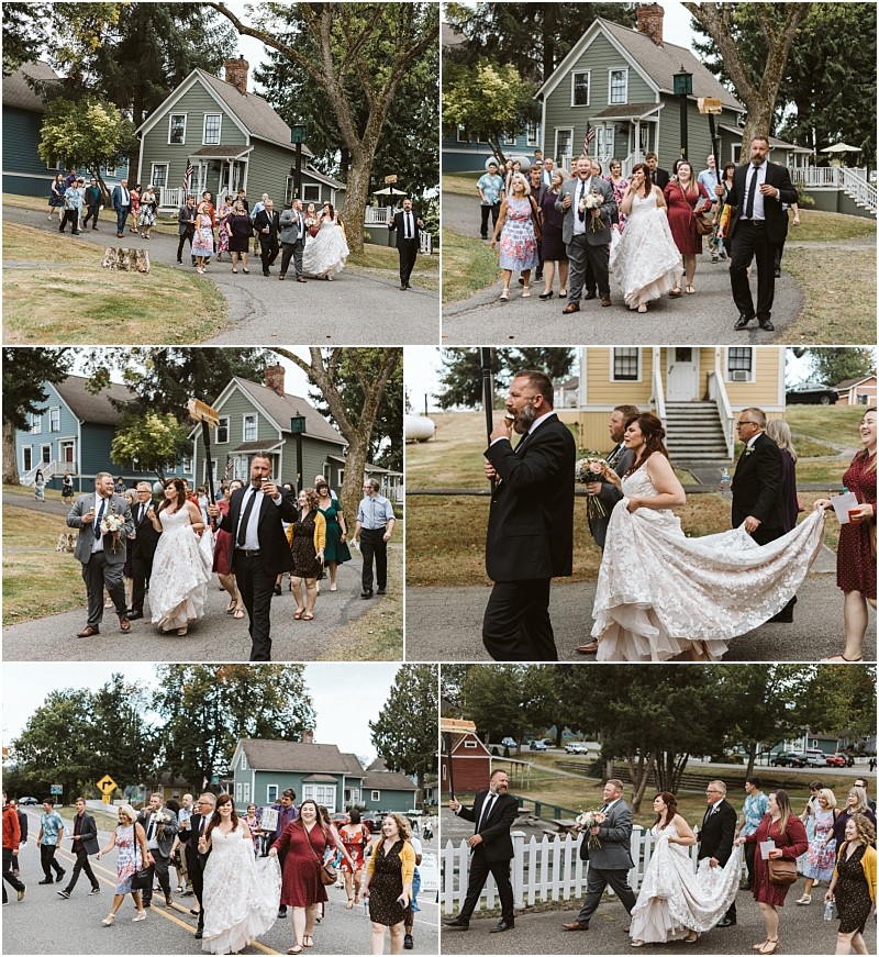 Premier Snohomish & Seattle Wedding Photographer | GSquared Weddings Photography A joyful Snohomish wedding procession moves down a neighborhood street, with the bride in a white gown, groom, guests, musicians, and pets walking together past houses and trees on a sunny day. 47.9129° N, 122.0982° W | Serving Snohomish, Seattle , Orlando & Beyond