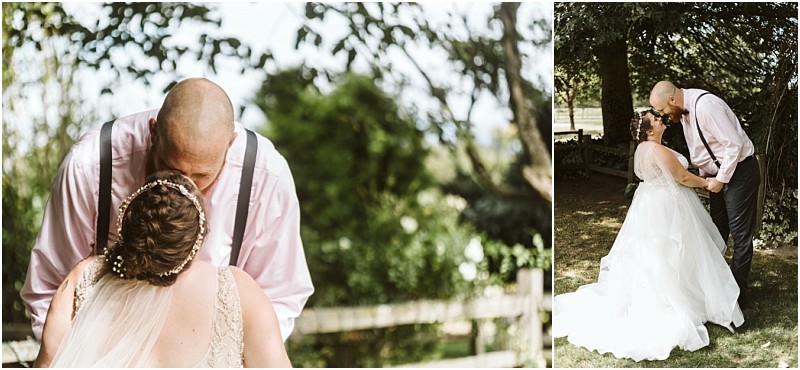 Premier Snohomish & Seattle Wedding Photographer | GSquared Weddings Photography A bride and groom share a tender moment outdoors during their Snohomish Seattle wedding; the groom, in a pink shirt and suspenders, kisses his bride beneath the shade of trees in a sunlit garden setting. 47.9129° N, 122.0982° W | Serving Snohomish, Seattle , Orlando & Beyond