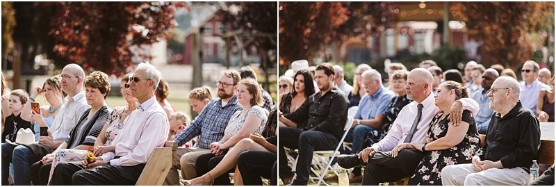 Premier Snohomish & Seattle Wedding Photographer | GSquared Weddings Photography A group of people seated outdoors at a Snohomish wedding, attentively watching the event. The audience includes men and women of various ages in semi-formal attire, with trees and sunlight in the background. 47.9129° N, 122.0982° W | Serving Snohomish, Seattle , Orlando & Beyond