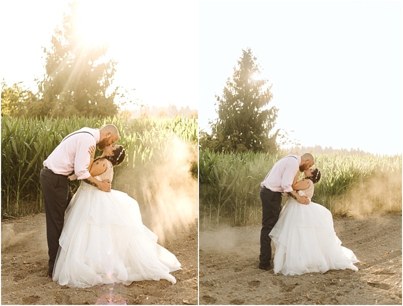 Premier Snohomish & Seattle Wedding Photographer | GSquared Weddings Photography A couple in wedding attire shares a romantic kiss outdoors at sunset near Snohomish, surrounded by sunlight and dust by a field of tall green corn, perfect for a Seattle Wedding Engagement with trees in the background. 47.9129° N, 122.0982° W | Serving Snohomish, Seattle , Orlando & Beyond
