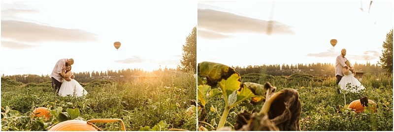 Premier Snohomish & Seattle Wedding Photographer | GSquared Weddings Photography A couple in wedding attire poses in a sunlit Snohomish pumpkin patch, surrounded by green plants and pumpkins, with a hot air balloon floating in the sky—capturing the magic of a Seattle wedding engagement. 47.9129° N, 122.0982° W | Serving Snohomish, Seattle , Orlando & Beyond