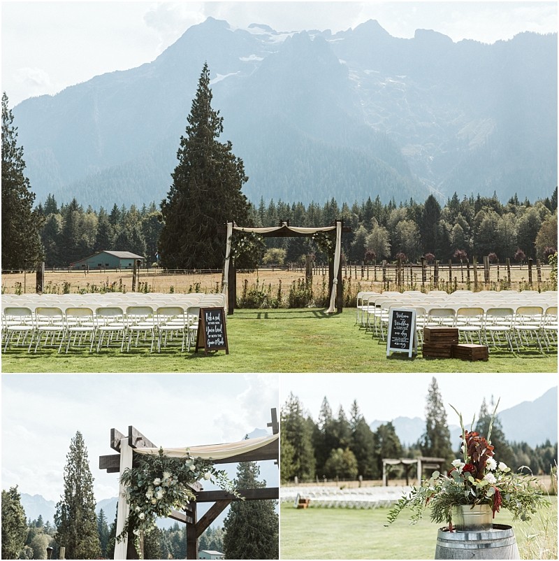 Premier Snohomish & Seattle Wedding Photographer | GSquared Weddings Photography An outdoor Snohomish wedding ceremony setup on a lawn with white chairs facing a wooden arch, decorated with greenery, set against a scenic backdrop of mountains, tall pine trees, and clear sky—perfect for a Seattle engagement celebration. 47.9129° N, 122.0982° W | Serving Snohomish, Seattle , Orlando & Beyond