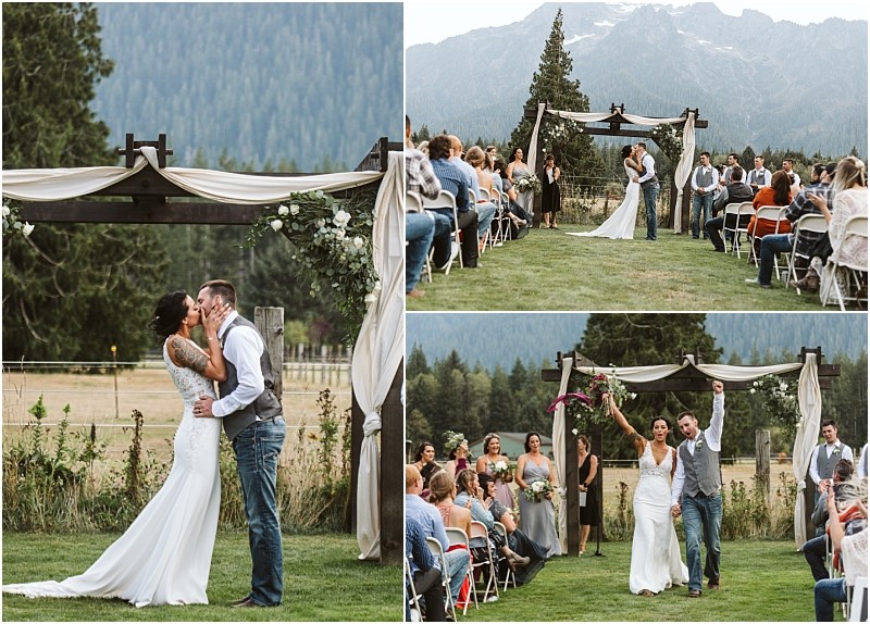Premier Snohomish & Seattle Wedding Photographer | GSquared Weddings Photography A bride and groom kiss and celebrate during a romantic Snohomish wedding ceremony with guests on either side and mountains in the background. The couple walks joyfully down the aisle under an arbor with white drapes. 47.9129° N, 122.0982° W | Serving Snohomish, Seattle , Orlando & Beyond