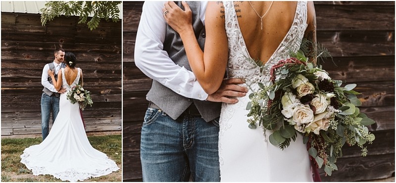 Premier Snohomish & Seattle Wedding Photographer | GSquared Weddings Photography A bride in a white dress holding a bouquet stands with her groom in jeans and a vest, embracing outside by a rustic wooden wall. The bride’s back and floral bouquet are prominently visible at this charming Snohomish Seattle wedding. 47.9129° N, 122.0982° W | Serving Snohomish, Seattle , Orlando & Beyond