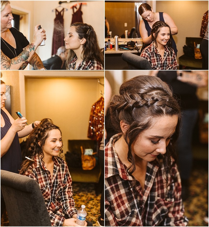 Premier Snohomish & Seattle Wedding Photographer | GSquared Weddings Photography A young woman in a plaid shirt gets her hair styled and makeup applied by two stylists. She smiles and looks relaxed in a cozy room with dresses hanging in the background, preparing for her Snohomish wedding or Seattle engagement. 47.9129° N, 122.0982° W | Serving Snohomish, Seattle , Orlando & Beyond