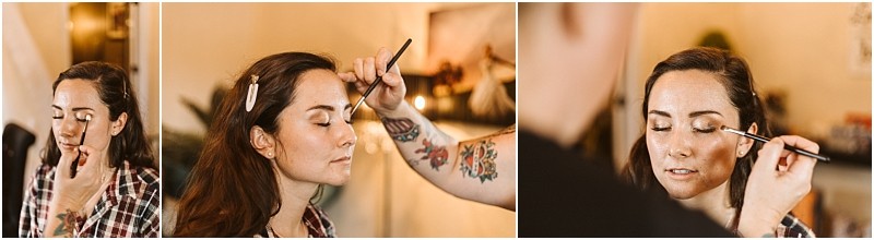 Premier Snohomish & Seattle Wedding Photographer | GSquared Weddings Photography A woman with brown hair sits calmly as a makeup artist applies eyeshadow with a brush. Ready for her Snohomish wedding engagement, she wears a plaid shirt and hair clips, while the softly blurred background adds a dreamy touch. 47.9129° N, 122.0982° W | Serving Snohomish, Seattle , Orlando & Beyond