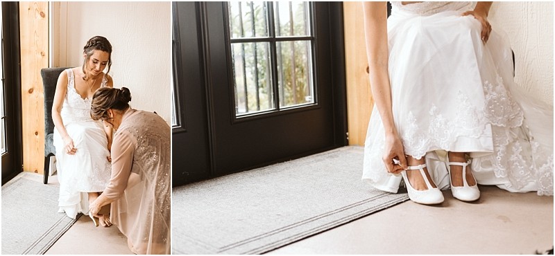 Premier Snohomish & Seattle Wedding Photographer | GSquared Weddings Photography A bride in a white dress sits indoors in Snohomish while another woman helps her adjust her shoes. The bride’s lace dress and white heels are visible as she prepares for her Seattle wedding, with natural light streaming through a nearby glass door. 47.9129° N, 122.0982° W | Serving Snohomish, Seattle , Orlando & Beyond