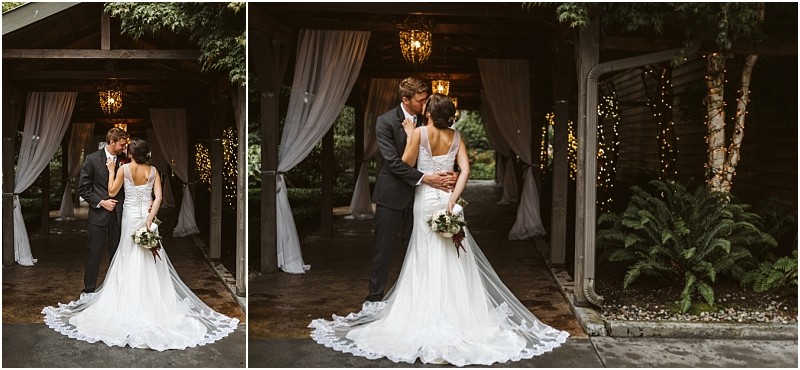 Premier Snohomish & Seattle Wedding Photographer | GSquared Weddings Photography A bride and groom stand close together under a wooden pergola draped with white curtains and string lights at their charming Snohomish wedding. The bride holds a bouquet, the groom wears a dark suit, and lush greenery surrounds this romantic Seattle engagement. 47.9129° N, 122.0982° W | Serving Snohomish, Seattle , Orlando & Beyond