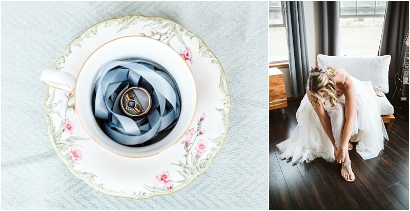Premier Snohomish & Seattle Wedding Photographer | GSquared Weddings Photography A gold ring on blue ribbon inside a floral teacup sits on pale fabric. Nearby, a bride in a white dress bends to fasten her shoe—a bright moment from a Snohomish Seattle wedding with elegant wood floors. 47.9129° N, 122.0982° W | Serving Snohomish, Seattle , Orlando & Beyond