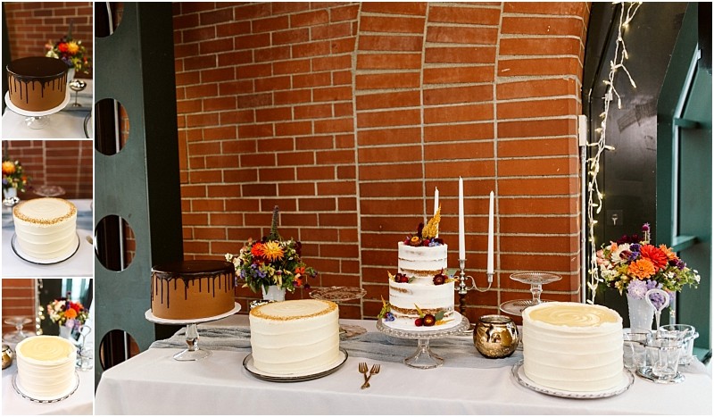 Premier Snohomish & Seattle Wedding Photographer | GSquared Weddings Photography A dessert table at a Snohomish wedding with four cakes—two adorned in chocolate drips, two with white frosting—surrounded by vibrant flower arrangements and candlesticks, set before a rustic brick wall. Perfect for a Seattle engagement celebration. 47.9129° N, 122.0982° W | Serving Snohomish, Seattle , Orlando & Beyond