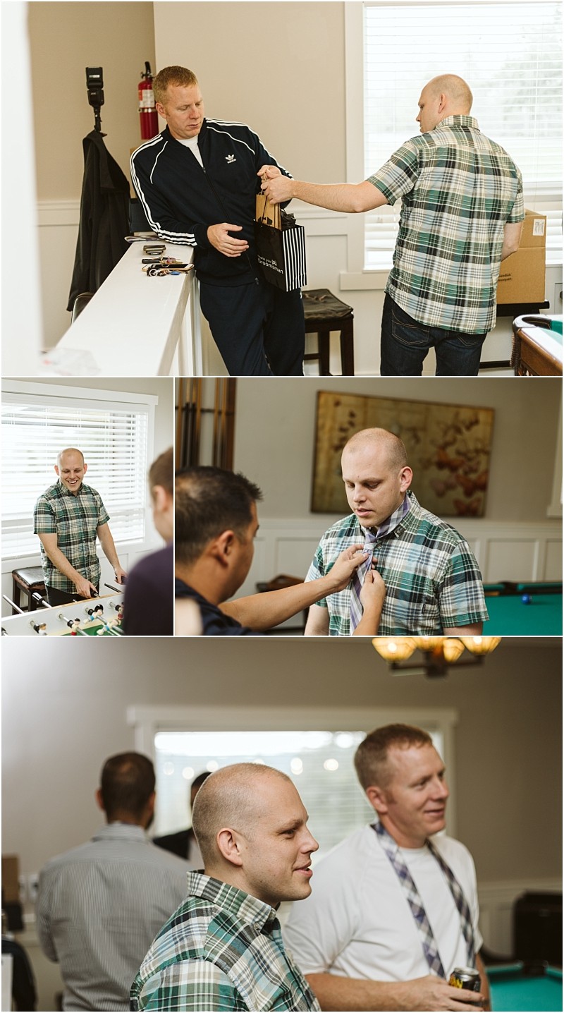 Premier Snohomish & Seattle Wedding Photographer | GSquared Weddings Photography A group of men in casual clothes prepare for a Snohomish wedding indoors; one man receives a gift, looks in the mirror, and gets help adjusting his shirt while chatting and laughing with friends. 47.9129° N, 122.0982° W | Serving Snohomish, Seattle , Orlando & Beyond